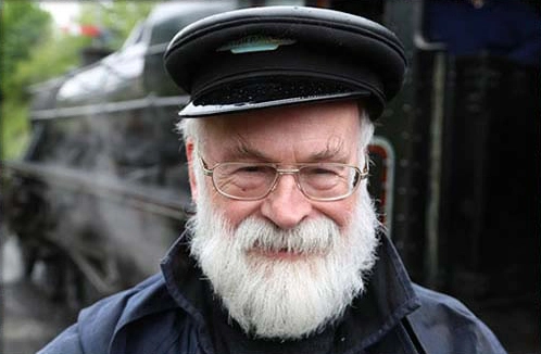 Terry Pratchett in 2015, train in the background